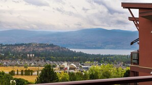 A residential area with houses, a hill, and a lake. - Corner Unit w Large Deck & Amazing View (West Kelowna)