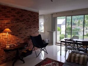 Relax in this inviting space with a brick wall, large window, and comfortable seating area.
