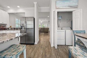 A modern kitchen with a stainless steel refrigerator, a built-in water dispenser, and a granite countertop. - Rare find in the heart of North Myrtle Beach (North Myrtle Beach)