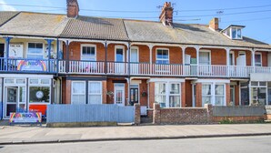 A two-story building with a shop on the ground floor and a balcony on the upper floor.