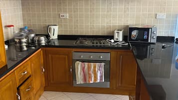 Comfort Apartment, Sea View | Private kitchenette | Full-size fridge, microwave, oven, stovetop