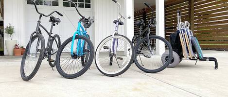 A covered outdoor area with bicycles and a wheelchair.