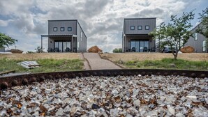 A modern building with two large windows and a pathway leading to it. - HACIENDA AMOR Summary (Johnson City)