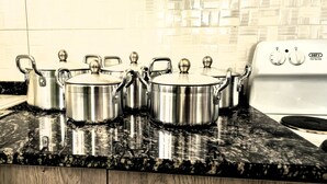 Stainless steel pots on a granite countertop in a kitchen with a tiled backsplash. - Eagle Weavers Nest (Livingstone)