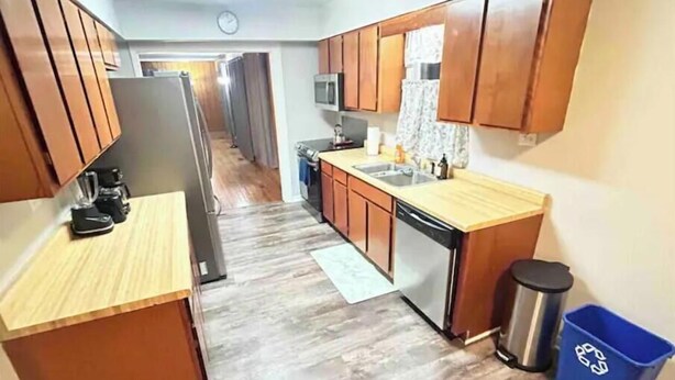 A kitchen with wooden cabinets, a stainless steel refrigerator, a microwave, and a dishwasher. - PROMO 10% WEEKLY AND 15% MONTHLY!
Spacious & Quaint Home Game Room LOTS of Beds! (wheaton)