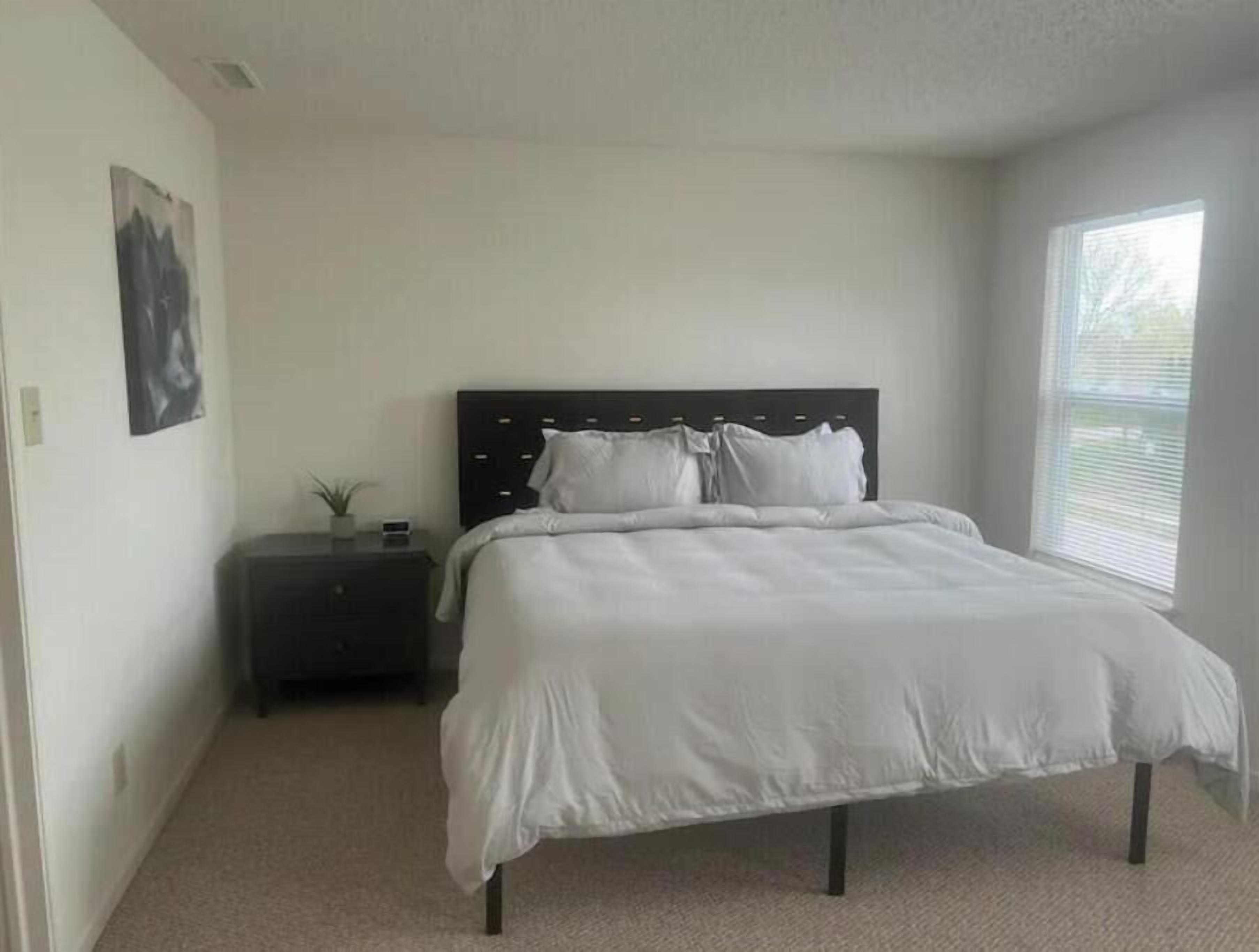 Bedroom 2 contains 1 king bed and ample clothing storage.