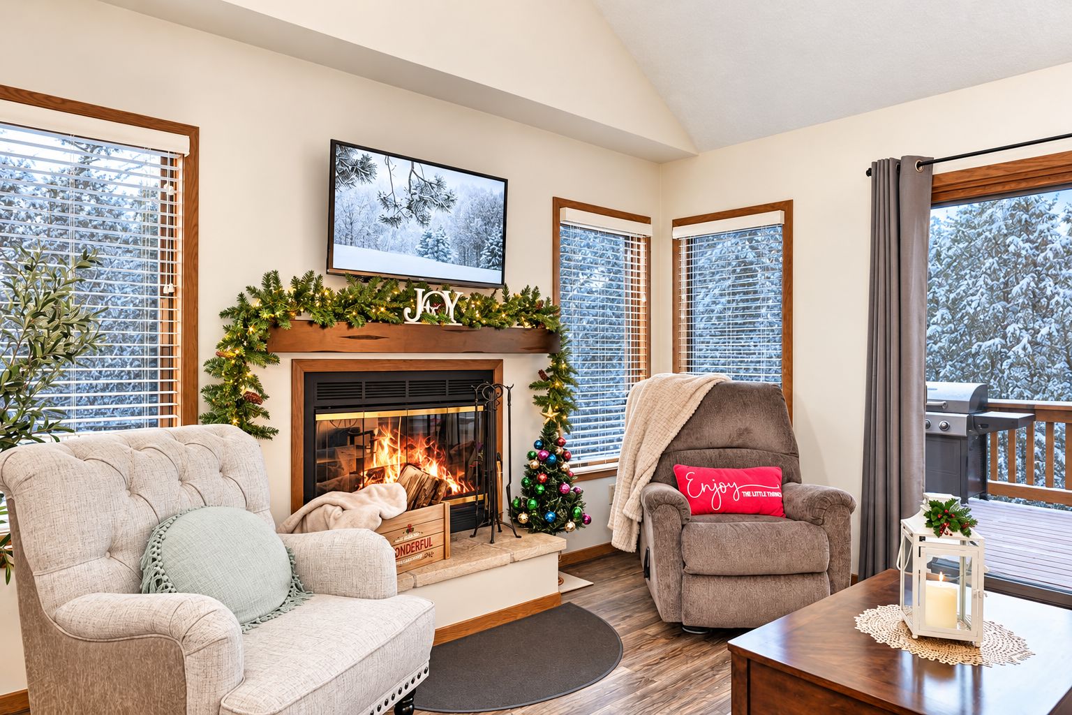 A cozy living room with a fireplace, a Christmas tree, and a comfortable seating area.