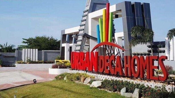 A modern building with a prominent sign reading "URBAN DEGA HOMES".