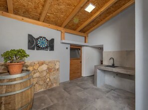 Cozy retreat with a dartboard, potted plant, and sink.