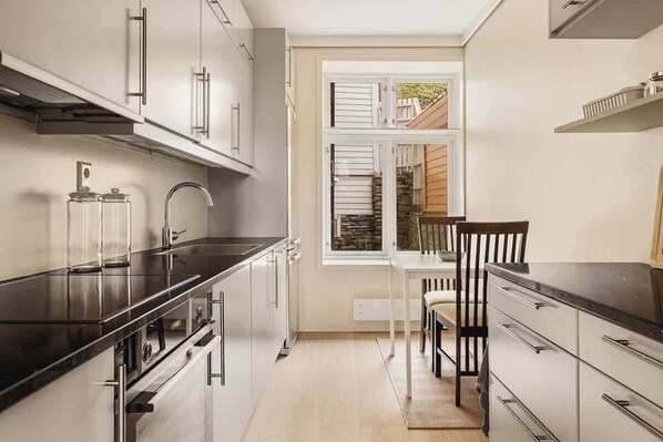 Enjoy cooking in this well-equipped kitchen with modern appliances and a dining area.