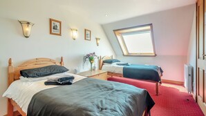 A bedroom with two beds, a skylight, and a red carpet. - Barnstable - UK46888 (Shannochie)