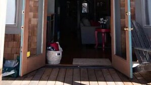A house with a sloped roof, wooden exterior, and a front door leading to an interior with a visible living area. - Plaza Perch~Downtown~Walkable (Arcata)