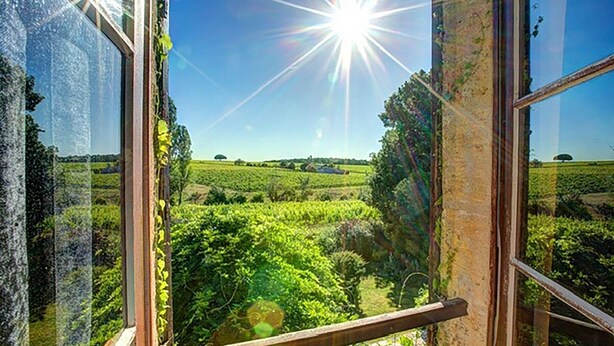 A view through a window with a wooden frame, looking out onto a green landscape with trees and fields. - Beautiful Stone Farmhouse, Private Pool, Idyllic Setting Amongst Vineyards near Sainte-Foy-la-Grande (Sainte Foy la Grande)
