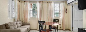 Economy Apartment, 1 Queen Bed, Private Bathroom, Ground Floor | Living area | 50-inch Smart TV with digital channels, Netflix, Hulu - Your quaint home just steps from beach (St. George's)