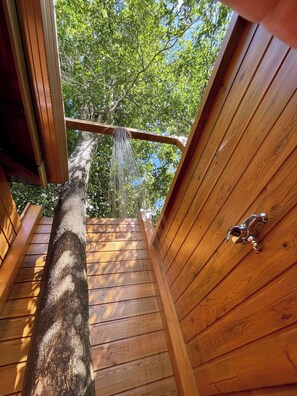 Enjoy a refreshing outdoor shower experience with a showerhead on this deck.