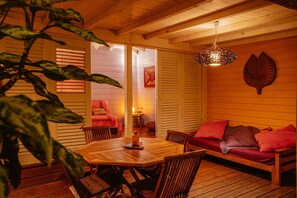 Relax in this inviting room with a dining table for two and a comfortable bench.