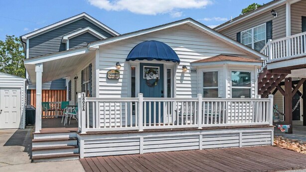 A two-story house with a covered porch and a deck. - 1802A Ocean Lakes Pet Friendly Golf Cart⛱️🏝️🩱🌊👙☀️🐚 (Myrtle Beach)