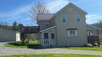 A two-story house with a covered porch and a garage.