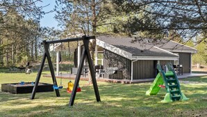 A playground with swings, slides, and a covered seating area. - Pet friendly home in ålbæk with WiFi (Ålbæk)