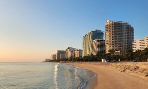 A beachfront hotel with high-rise buildings, sandy beach, and ocean view. - Luxury Condo w/ Rooftop Pool | 5-Min to Beach (Bay Harbor Islands)