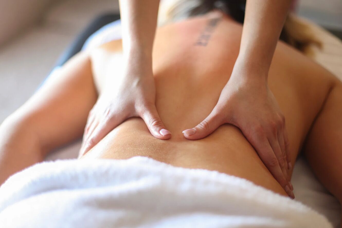 A person receiving a back massage.