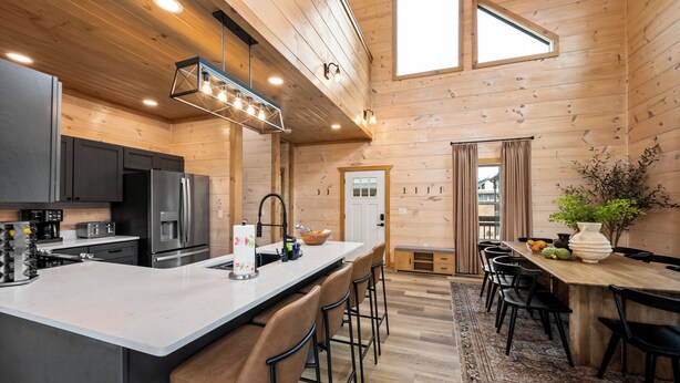 A modern kitchen with a large island, stainless steel appliances, and a wooden interior. - Central Loc*Luxury*Indoor Pool *Hot Tub *Dollywood (Pigeon Forge)