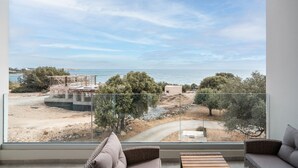 A balcony with a view of the sea, a sandy area, and some trees. - Apartment 'Tesoro Del Mare with Sea View 1' with Sea View, Wi-Fi and Air Conditioning (Pefki)