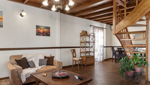 Ein Wohnzimmer mit einer Couch, einem Couchtisch und einer Treppe.