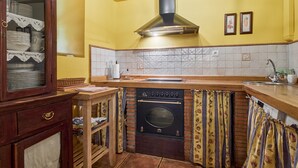 A kitchen with a stove, oven, and sink.