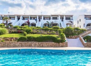 Un hôtel doté d’une piscine, de bâtiments à plusieurs étages et d’un jardin aménagé.