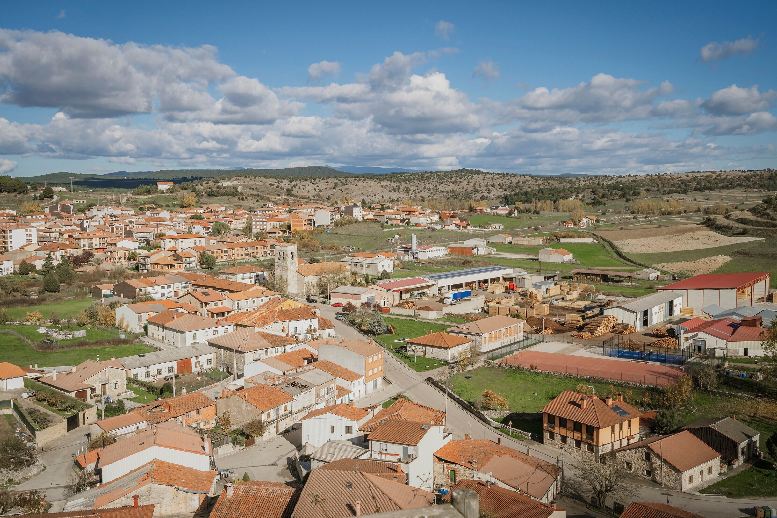 Un barrio residencial con casas, una iglesia y un pequeño centro urbano.