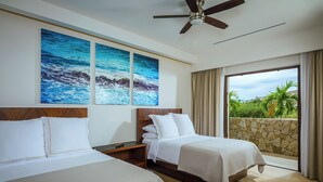 A hotel room with two beds, a ceiling fan, a stone wall, and a view of greenery. - Villa Oasis, a Luxury 6 BDR (San José del Cabo)