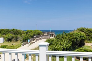 A beachside walkway leading to a wooden deck with a clear view of the ocean. - A Golden Opportunity: Semi-Oceanfront w/Heated Pool, Hot Tub and Across from Beach! (Corolla)