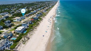 A coastal residential area with beachfront properties, a beach, and a clear view of the ocean. - A Golden Opportunity: Semi-Oceanfront w/Heated Pool, Hot Tub and Across from Beach! (Corolla)