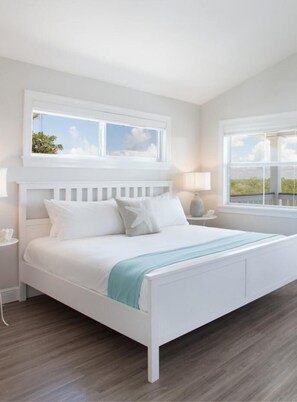 A white bed with a headboard, two bedside tables, and a window above the bed. - Isla Mamey: Boutique Resort, FREE Boat Dockage Sept-Oct Only! (Islamorada)