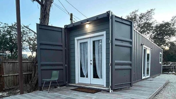 A compact, single-story structure with a front door and a small porch area. - EL948 (Canyon Lake)