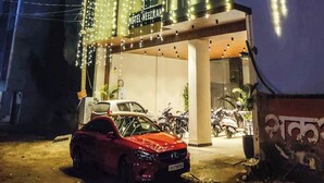 A hotel with a sign reading "HOTEL NEELKAR" and "FUKKALAN HOTEL" illuminated by string lights. - Hotel Neel Kamal (Jaipur)