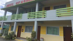 A two-story building with the sign "AWEI SEASHORE INN" at the top. - Awel Seashore Inn Baler (Baler)