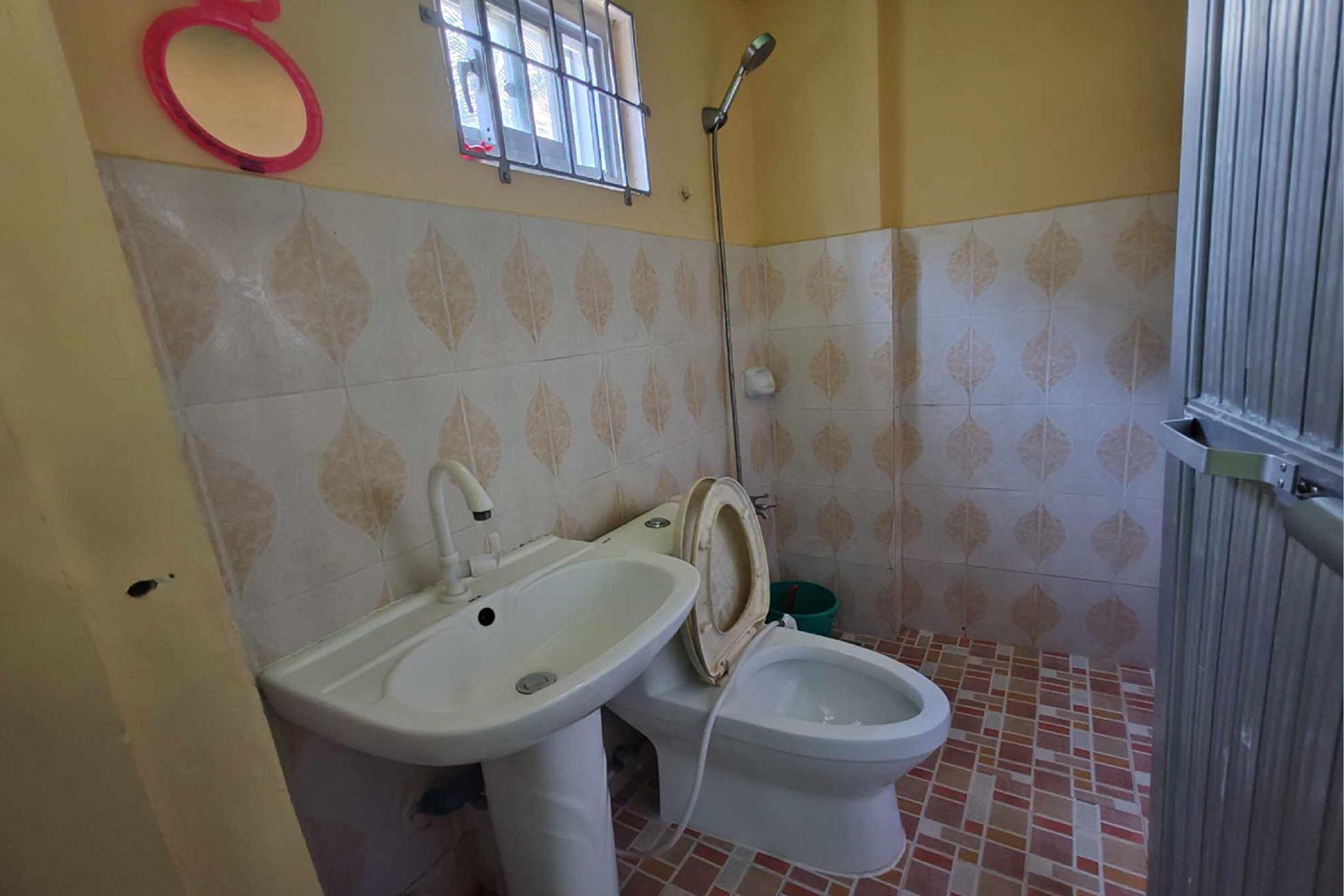 A bathroom with a sink, toilet, and shower.