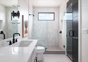 Shower, hair dryer, towels, shampoo
