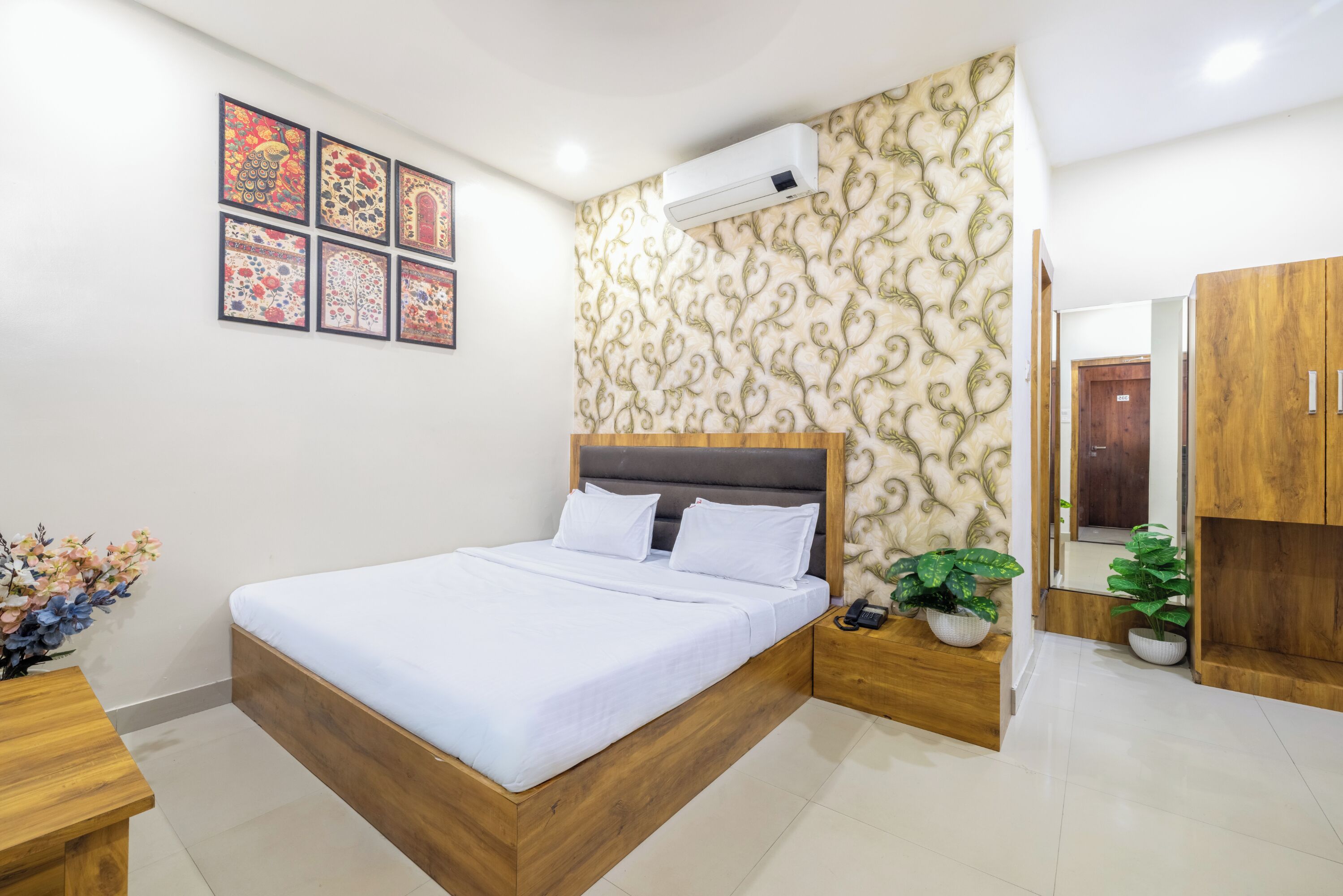 A modern bedroom with a wooden bed, a wall-mounted air conditioner, and a decorative wallpaper.