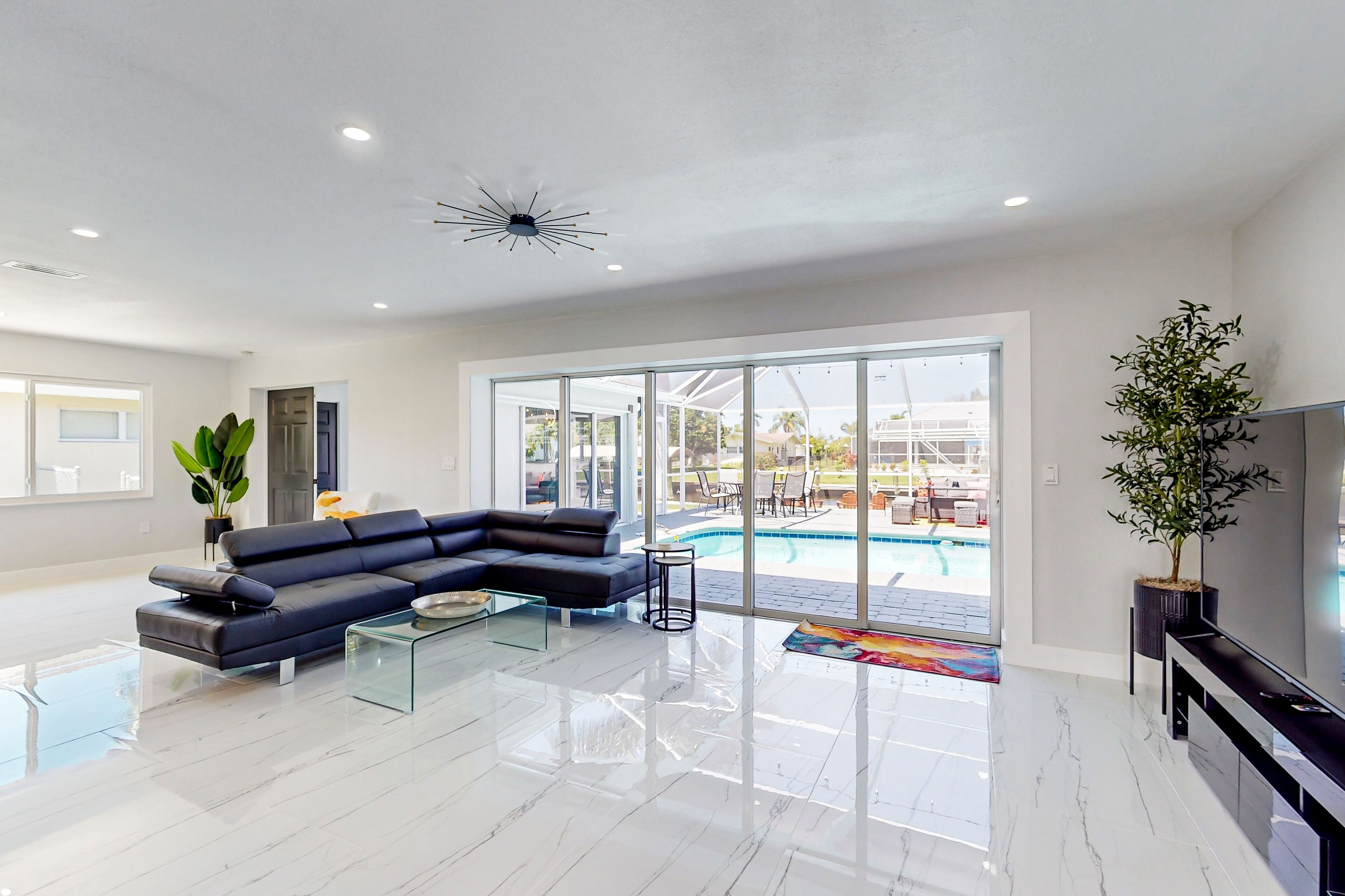 Updated dog-friendly waterfront home with a lanai, private pool, & canal view