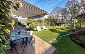 Enjoy dining or socializing in this outdoor space with a table and chairs.