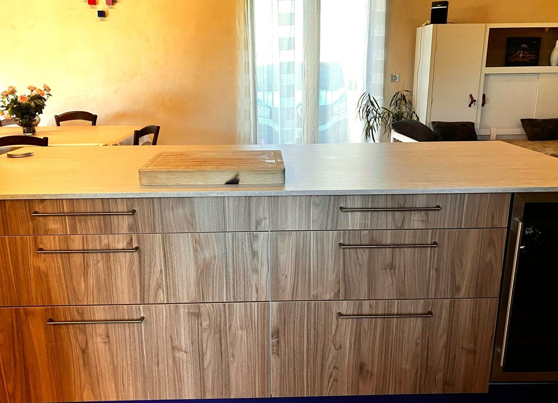 A kitchen with wooden cabinets, a countertop, and a dishwasher.