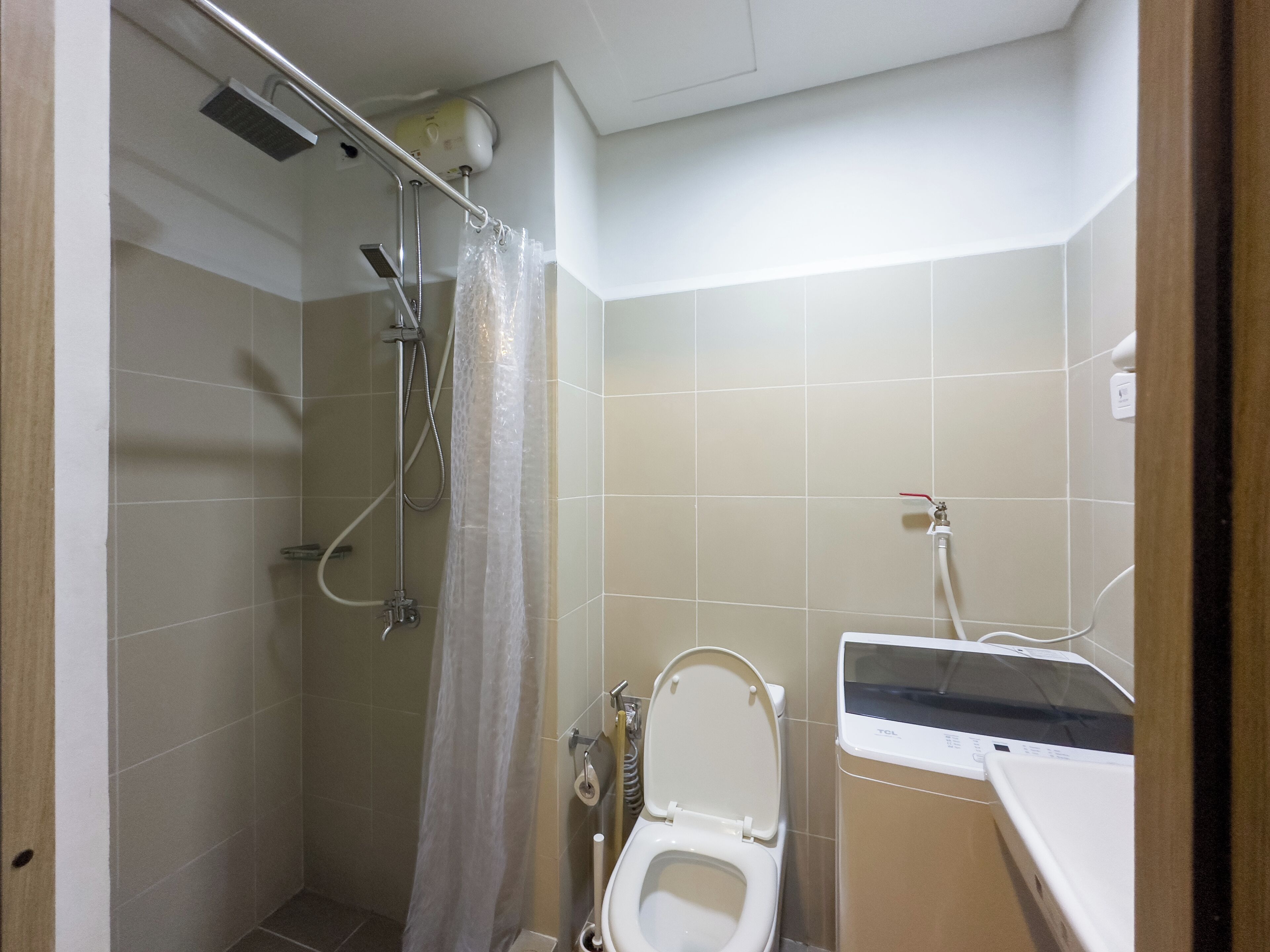 A small bathroom with a shower, toilet, and sink.