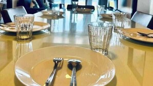 A conference room with a long table set for a meeting. - MACTAN NEWTOWN OMP FAMILY ROOM (Lapu-Lapu)