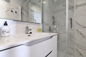 Shower, hair dryer, towels, toilet paper