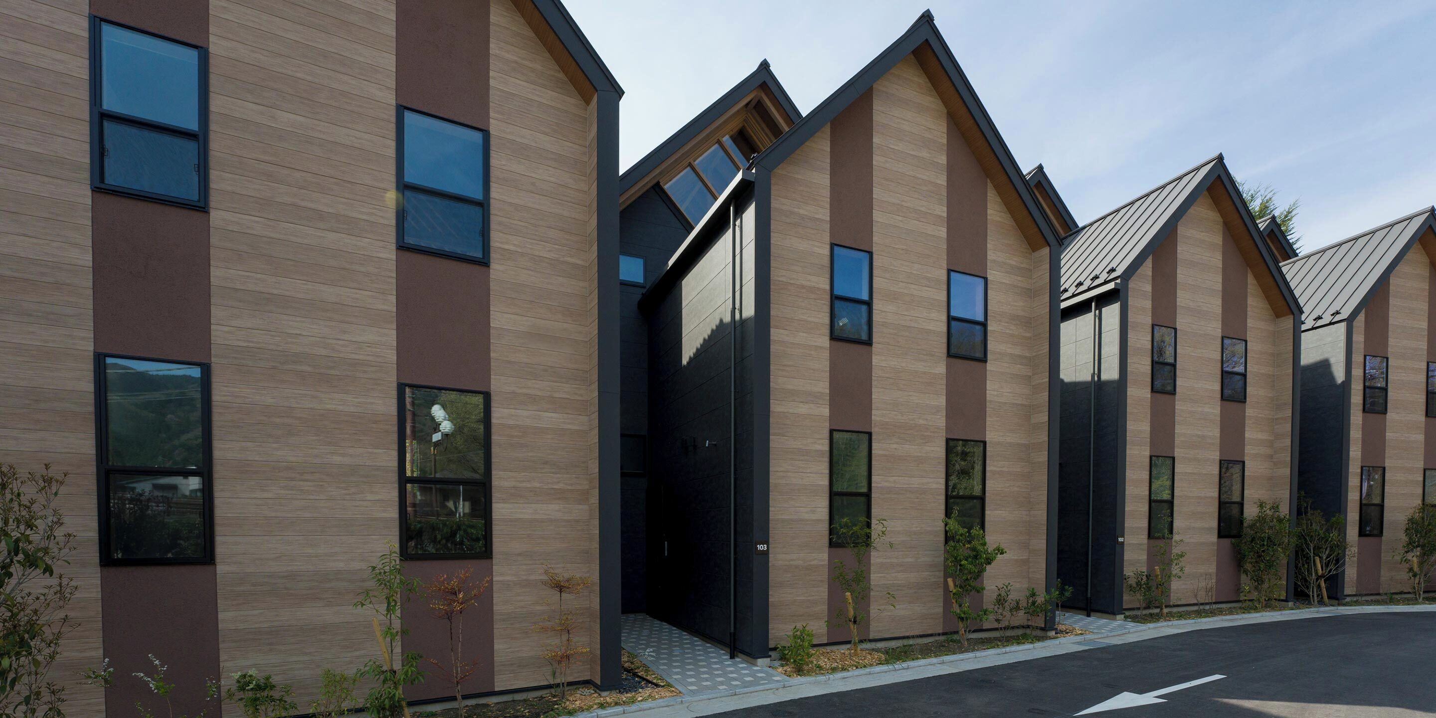 A modern building with a symmetrical facade, large windows, and a flat roof.