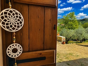 A wooden door with two decorative dreamcatchers and a view of an olive grove. - Oniropagida - Dream Catcher - House On Way To Sougia (Platanias)