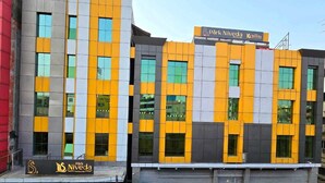 A modern building with a sign for 'Park Niveda' and a 'Shy' sign. - Park Niveda (Hyderabad)